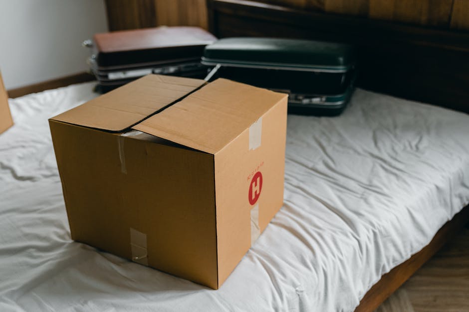 A person packing a rooftop cargo box with various items, demonstrating efficient usage of space and weight distribution.